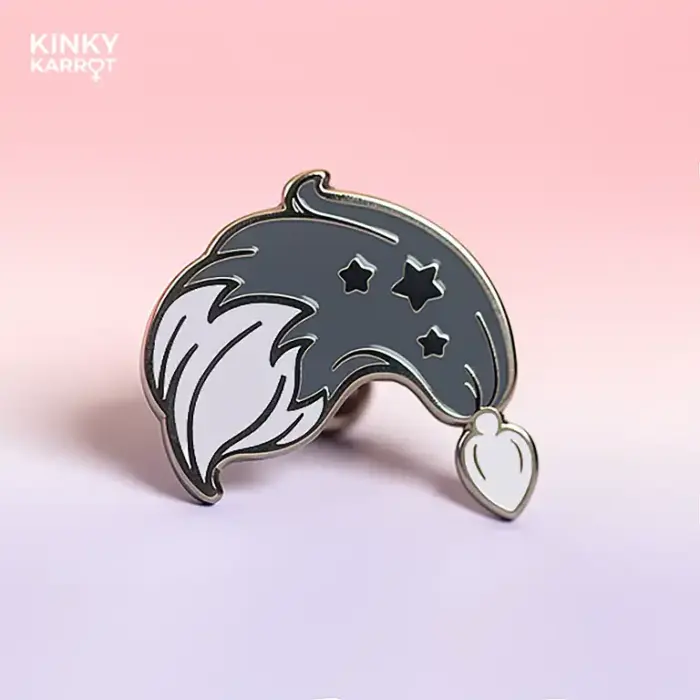 Black fox tail butt plug enamel pin with silver stars on a soft gradient background
