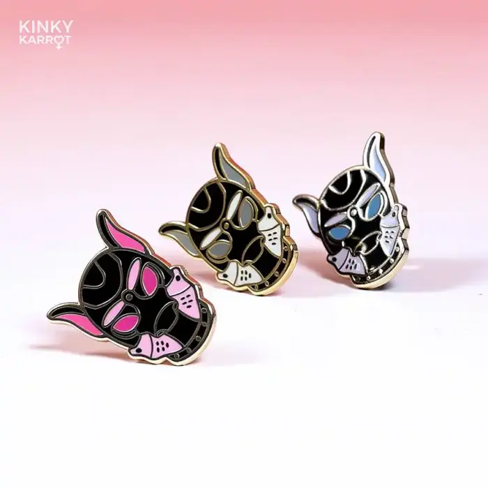 puppy play mask enamel pins in pink, blue, and grey variants side by side